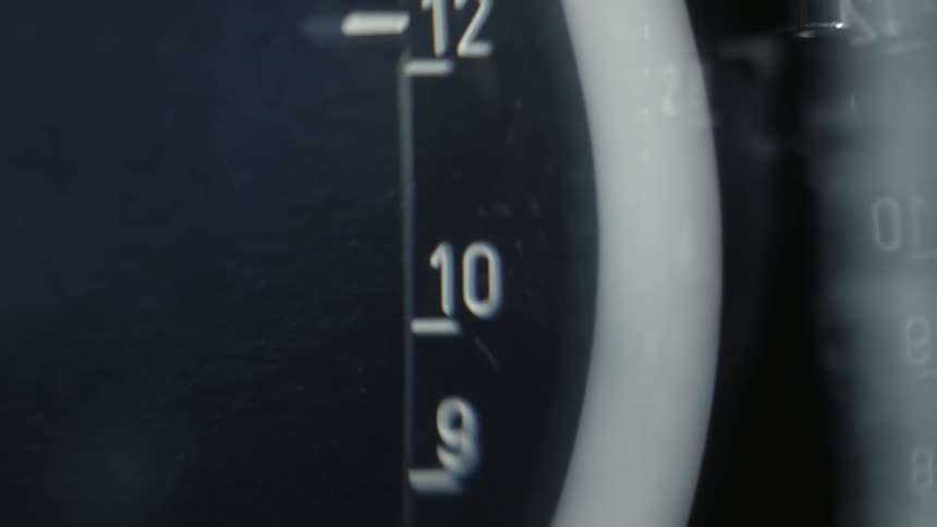 A closeup shot of a dial with numbers in focus while scrolling