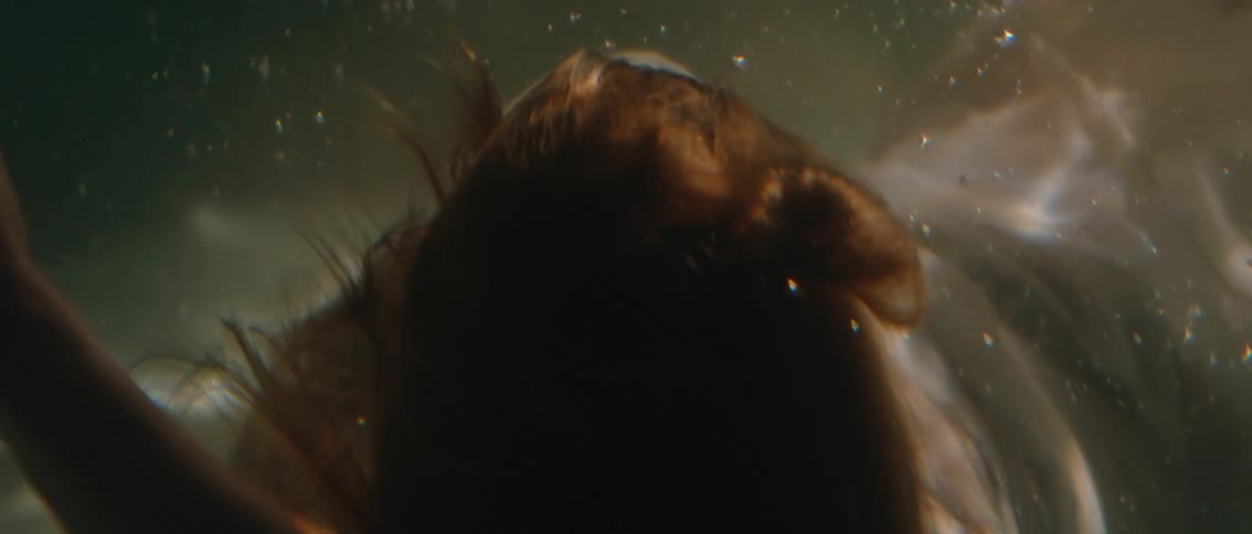 Woman in white dress submerged in water