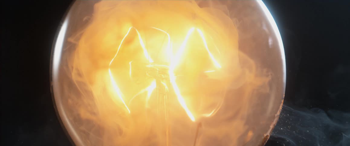 A light bulb illuminates and smokes