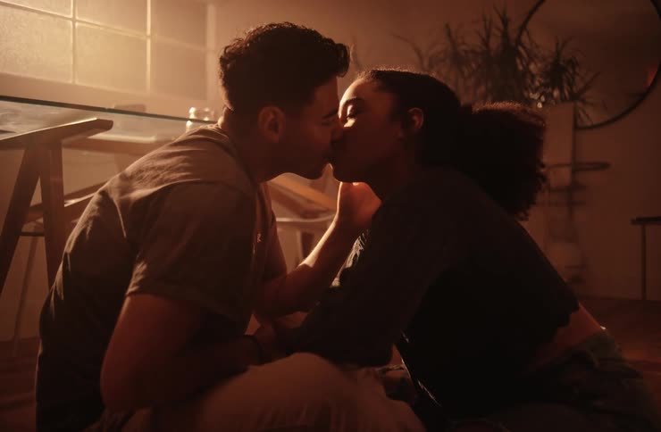 A couple lean in for a kiss