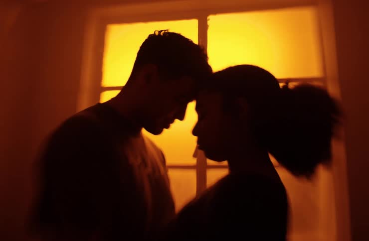 A couple hug in the dark room