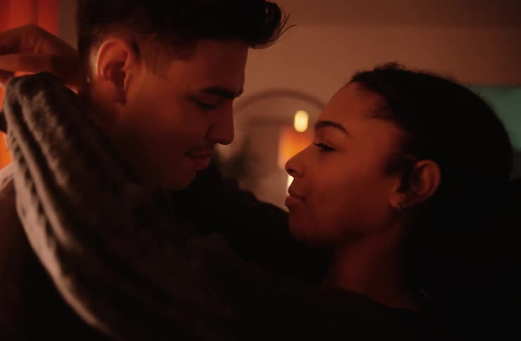 Young couple kisses while slow dancing at home