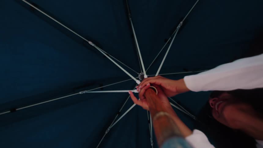 Cheerful woman opening a parasol