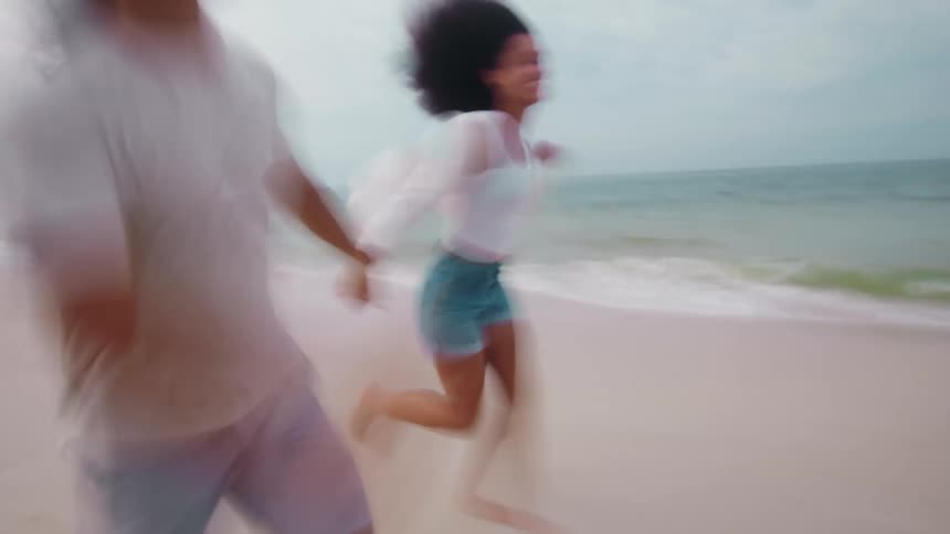 Two people race through the sand