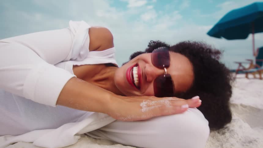 Woman laughing and relaxing at the beach