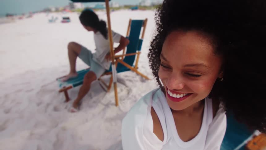 A man and woman are relaxing on the beach