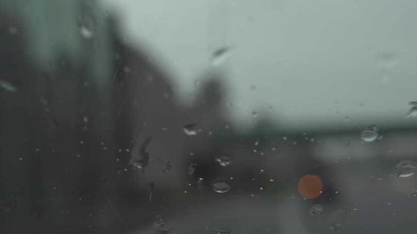Raindrops splattering on a window