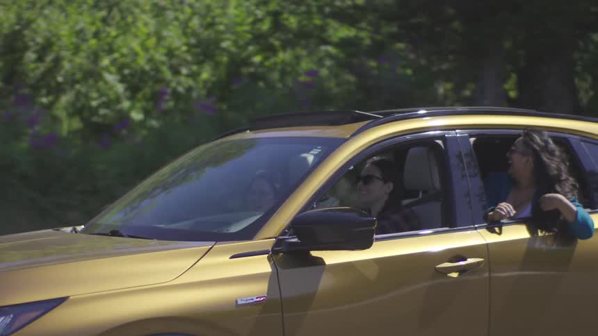 Three women having fun on a road trip in the car