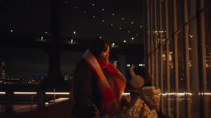 A woman and a girl at night in the city having fun dancing together