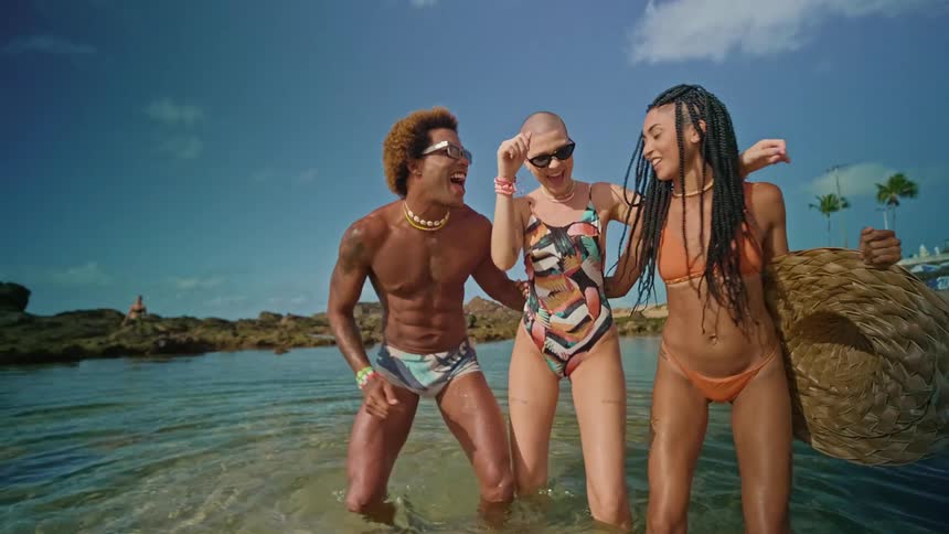 Friends dancing on the beach
