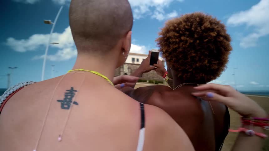 The women take a selfie while on vacation near the shore
