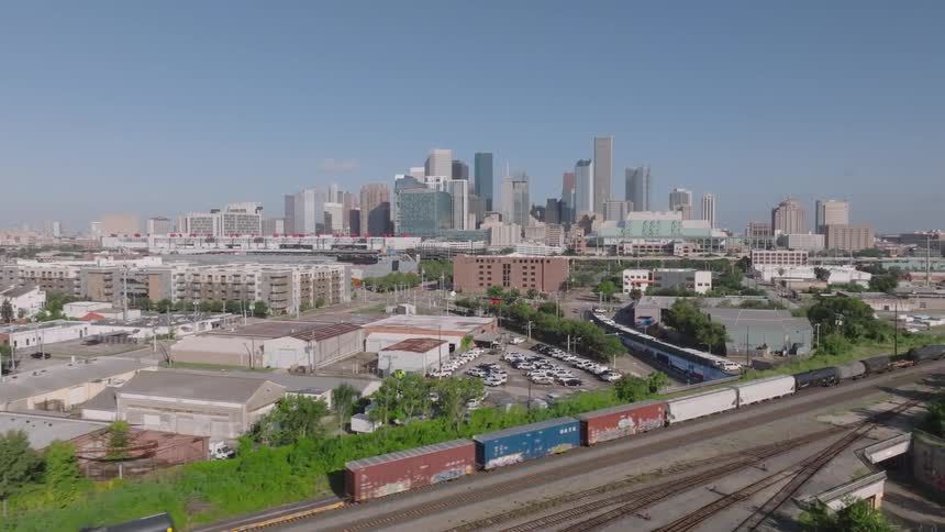 The cargo train passes by the city