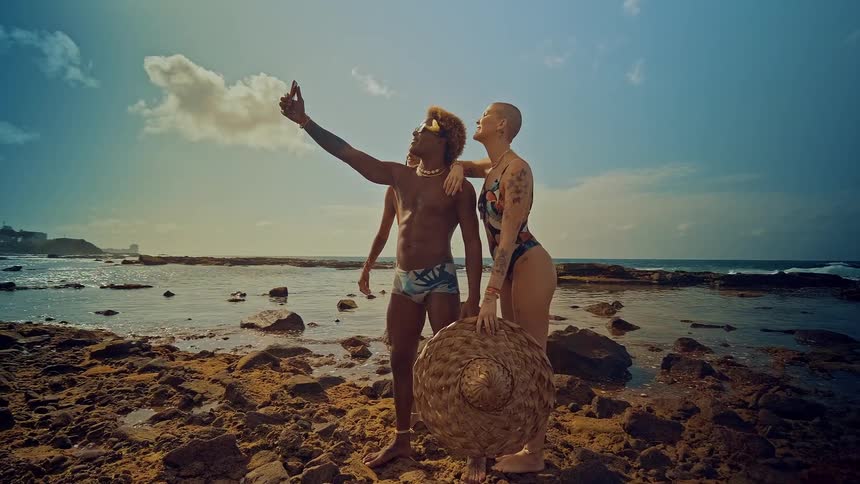 Friends taking a selfie on shoreline at the beach