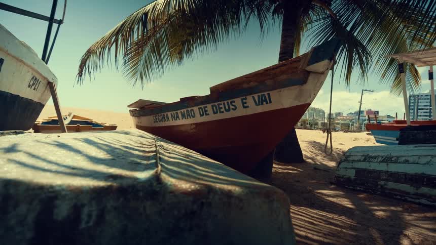 Old wooden boats stranded on the sand of a tropical beach