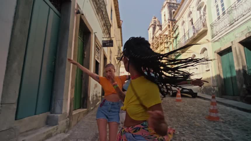 People dance through the street