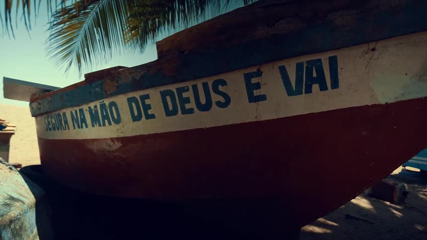 The first line of text on the boat reads segura na mo de deus e vai the second line of text which is smaller and less prominent appears to be a watermark or logo that says filmsupply