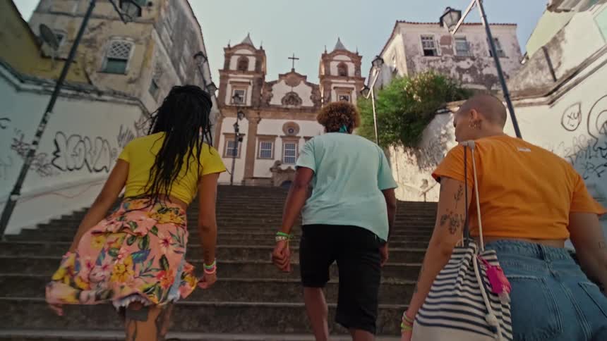 The tourists climb the long stone steps