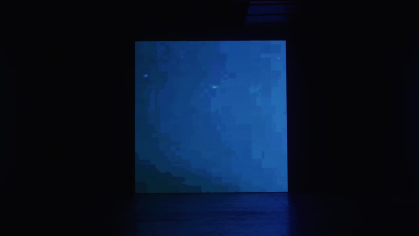 Screen displaying abstract lights in a dark room