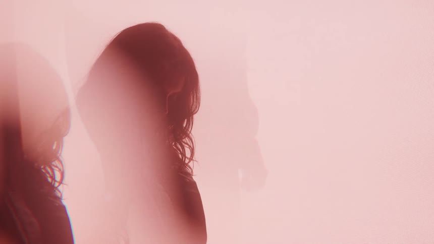 Silhouette of a woman in a bright environment