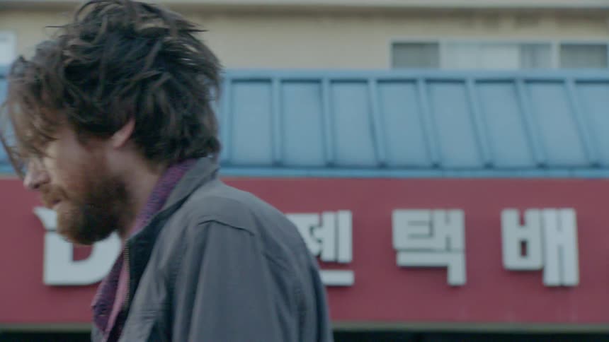Man walking past a storefront