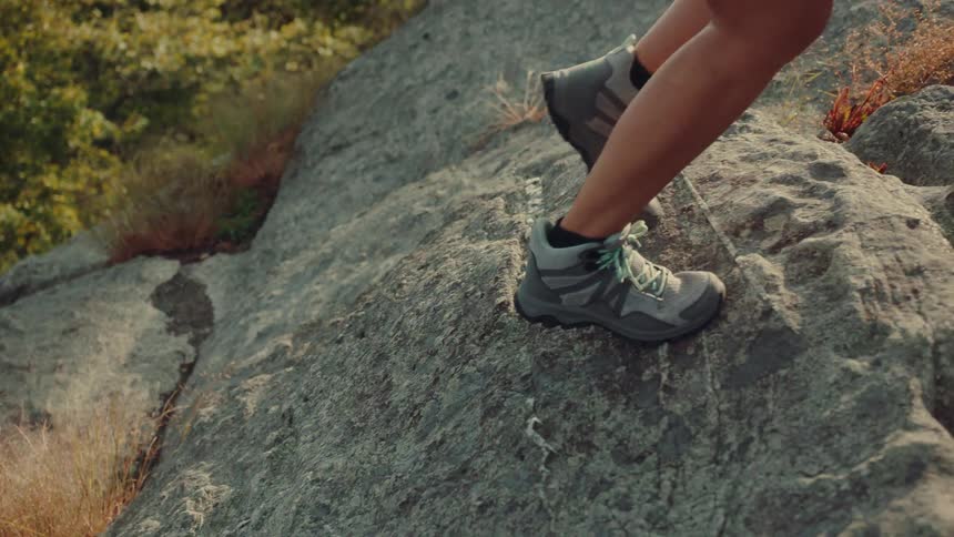 The video shows a man and a woman hiking on a rocky trail the first line is the womans path as she walks diagonally up and to the right toward the top of the frame the second line is a mans path following the womans a bit behind her