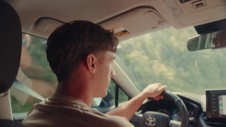 Two people taking while on a road trip through the forest
