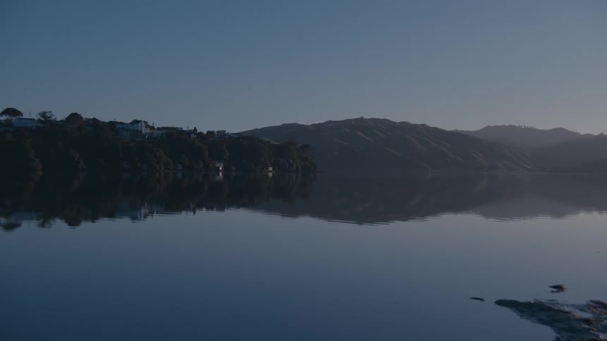 Calm lake with mountains in the background