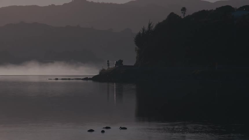Boat circles near the cliffs in the ocean