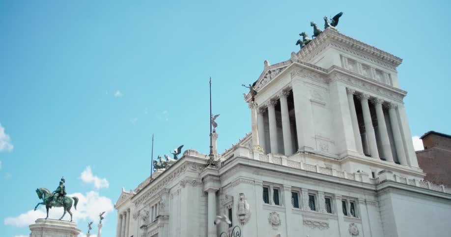 Birds fly around a large building