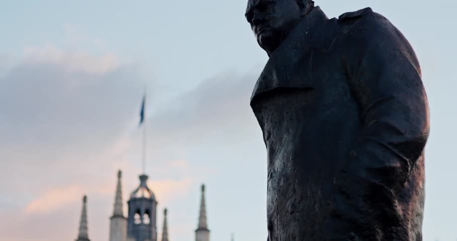 A statue of a man is in front of the building