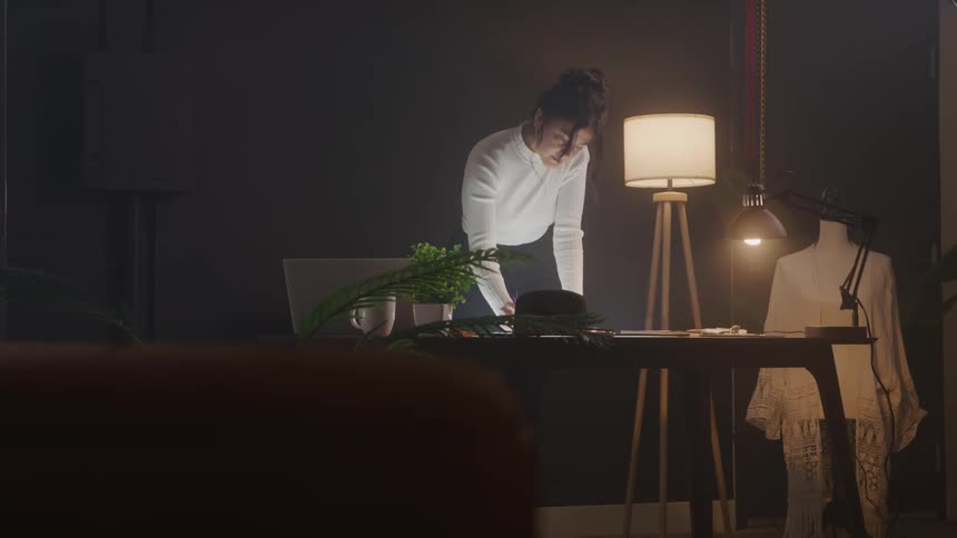 A woman is writing something on the table