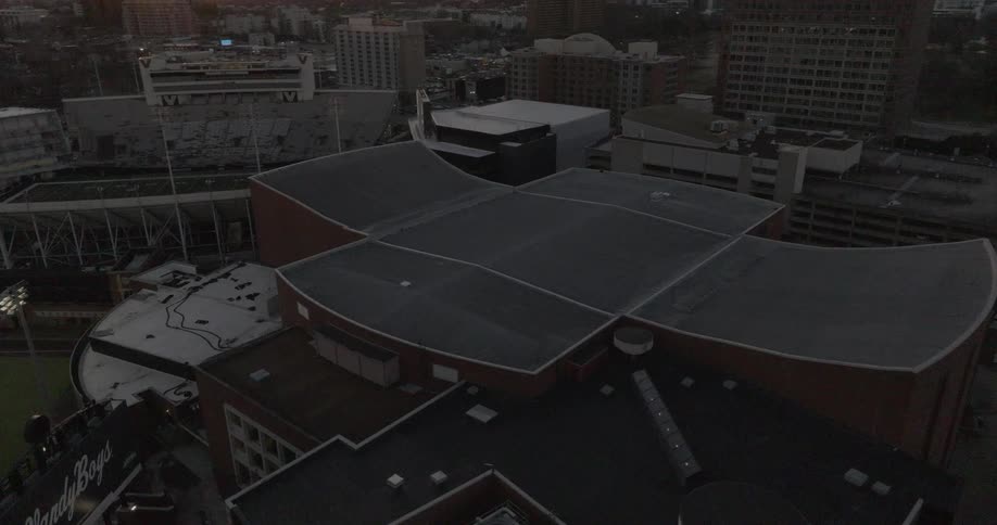 A stadium immediately next to a baseball field in the city