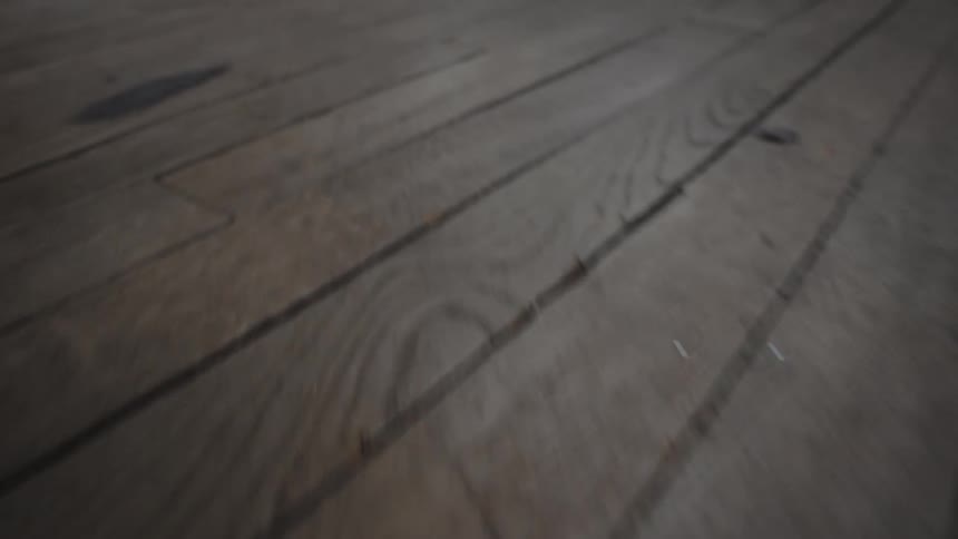 Aged wooden planks forming the floor of a room