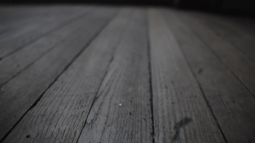 Panning along the floorboards