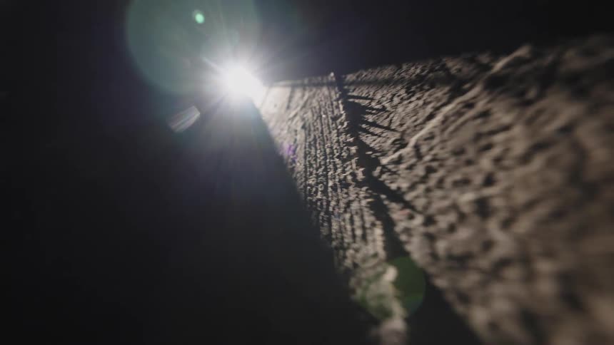 Light floods in through an open doorway to highlight a concrete floor