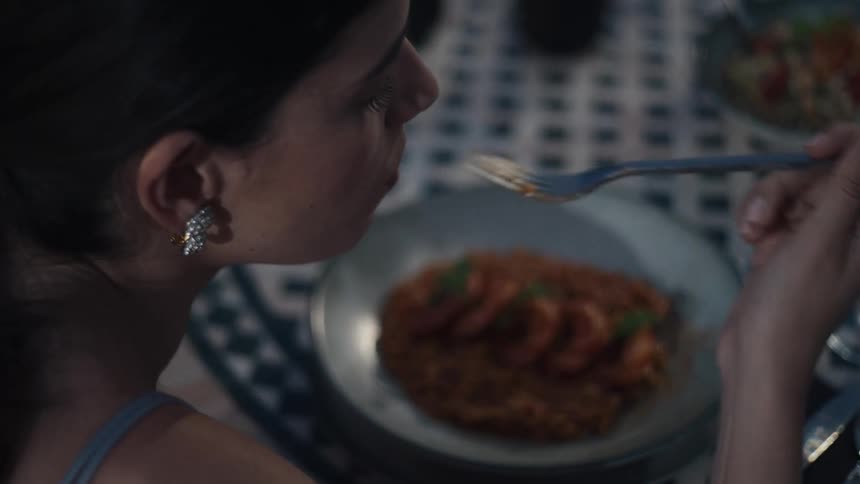 Woman eats shrimp and rice at table