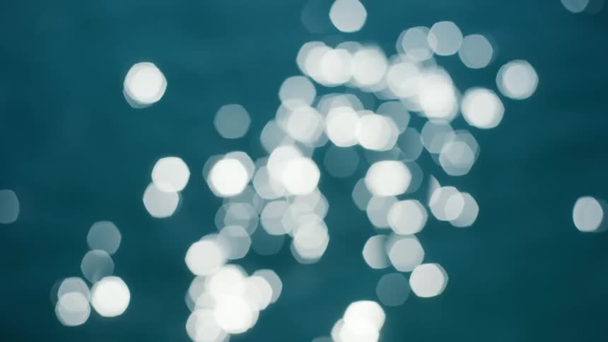 Bright reflections shimmering on the blue water surface