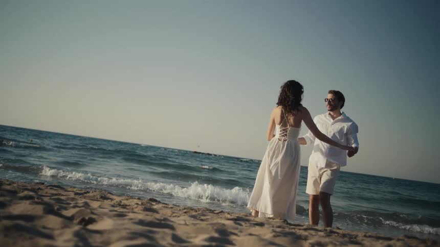 A couple dances on the beach