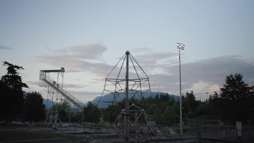Climbing structure in a playground with mountains in the background