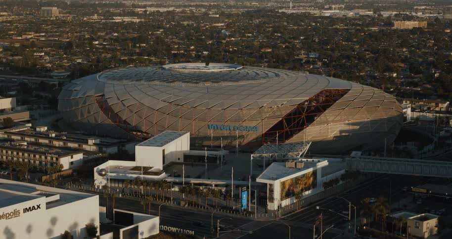 Modern ovalshaped stadium stands out in the middle of the urban area