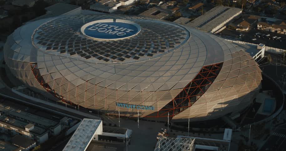 An aerial view of the intuit dome reveals its futuristic design and circular solarpaneled roof during daylight
