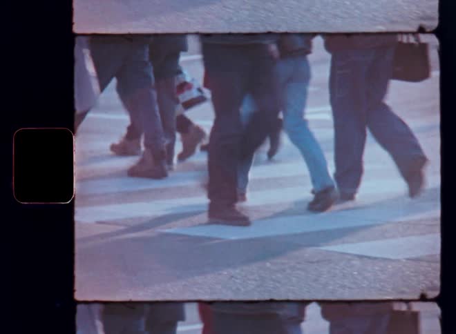People crossing a crosswalk in an urban area