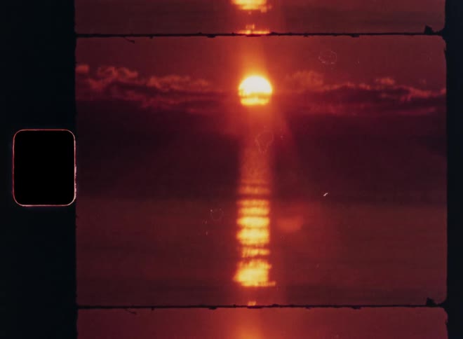 Sunset reflecting off the ocean as the sun sets below the clouds on the horizon