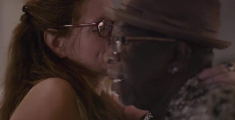 A man and woman talk and dance