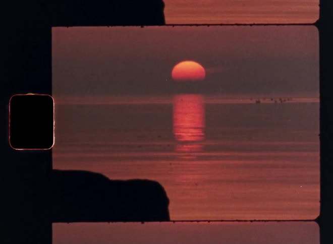 Sun sets on the horizon reflecting orange tones over the sea