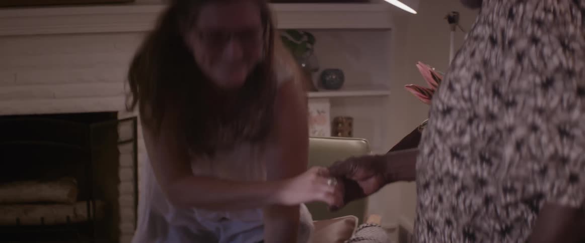 A man holds out a hand and helps up a woman