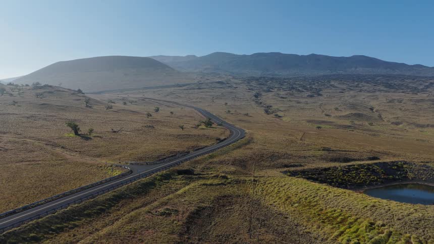 A road winds through a large field