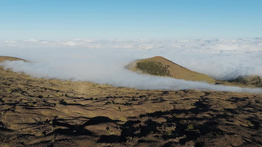 Mountains rise above the clouds