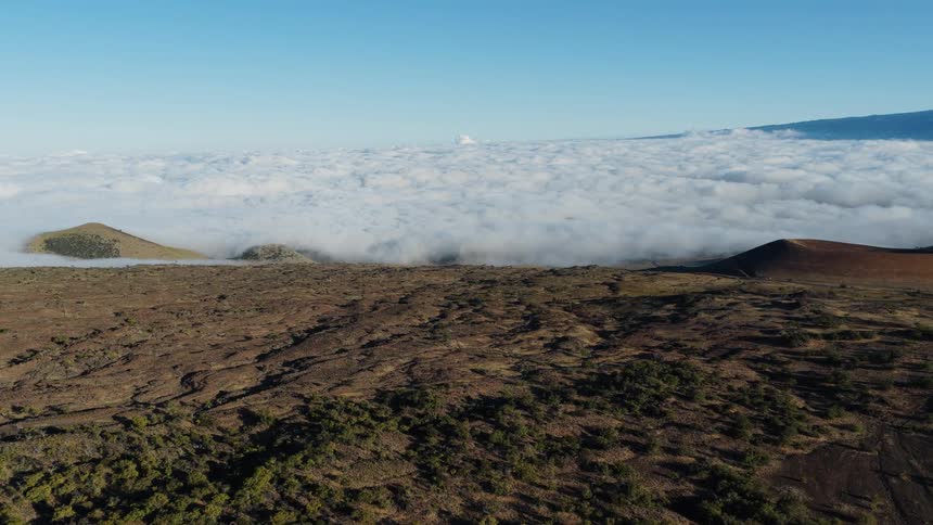 Mountains rise above the clouds
