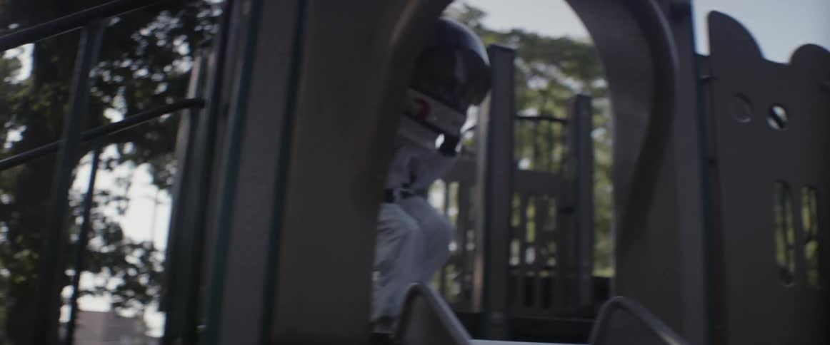A girl goes down a slide dressed as an astronaut